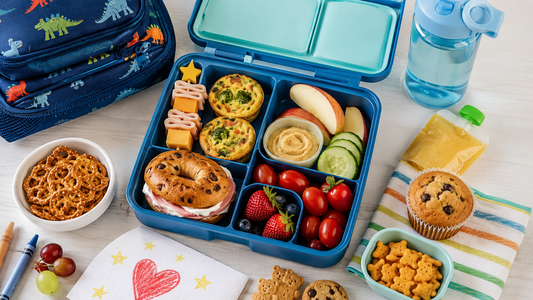An image of a kids' lunch box, water bottle, & lots of fantastic lunchbox treat deas