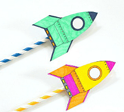 Two colorful paper rocket straws on a white background