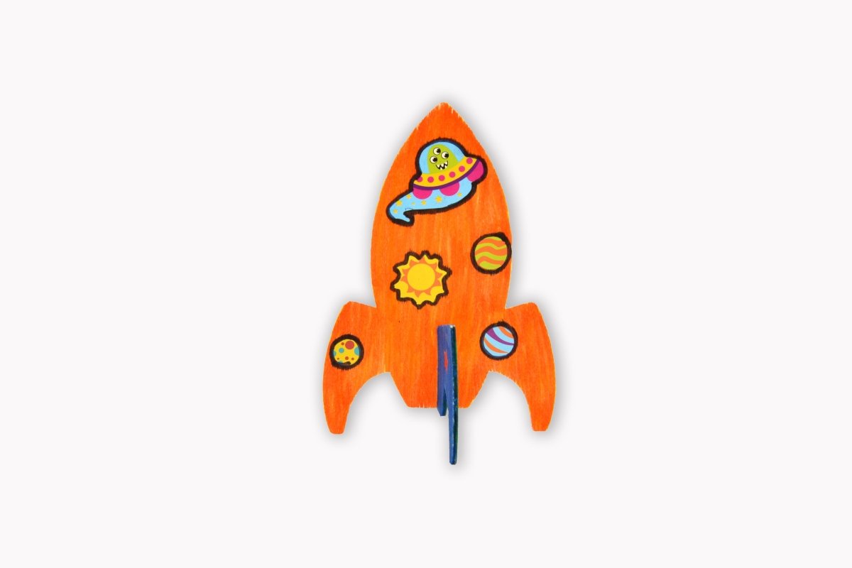 Wooden rocket ship with space-themed design on a white background