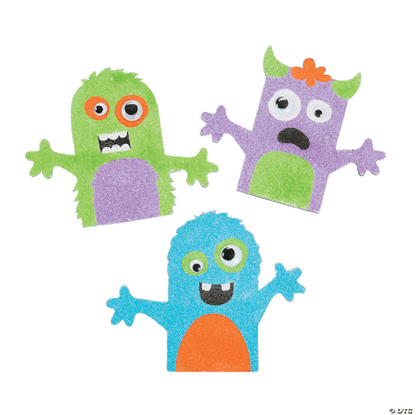 Three colorful monster crafts made of sand art on a transparent background