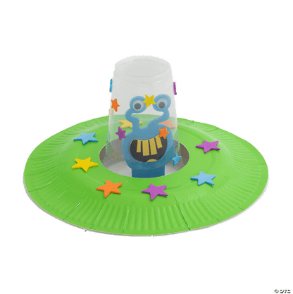 Alien craft with a colorful character on a green base with star-shaped decorations