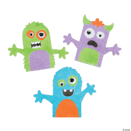 Three colorful monster craft made if sand art on a transparent background