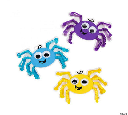 Three colorful spider toys in blue, purple, and yellow on a white background