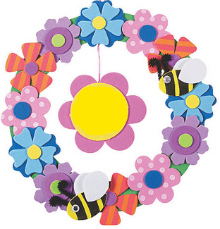 Colorful foam flower wreath with bumblebees on a white background