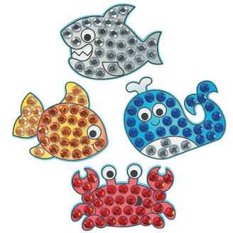 Decorative jewel mosaic of a fish, goldfish, whale, and crab with rhinestone embellishments on a white background.