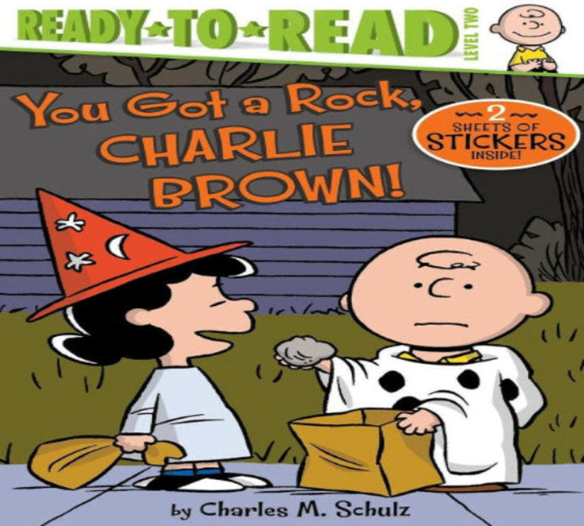 Book cover of 'You Got a Rock, Charlie Brown!' featuring characters in costumes with a Halloween theme.