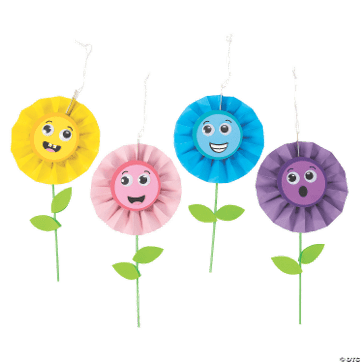 Four colorful flowers with smiling faces on a transparent background