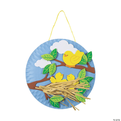 Decorative blue paper plate with chicks in a nest and tree branches on a white background