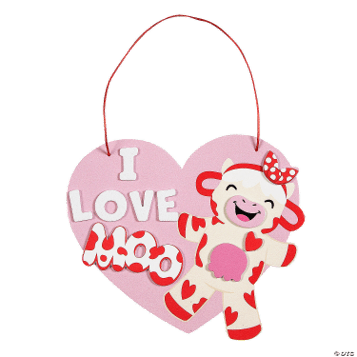 Heart-shaped craft with a cow design and 'I love you' text on a green background