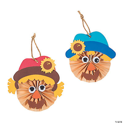 Two paper scarecrow crafts with colorful hats on a white background