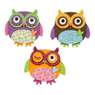 Three colorful glitter owl decorations on a white background